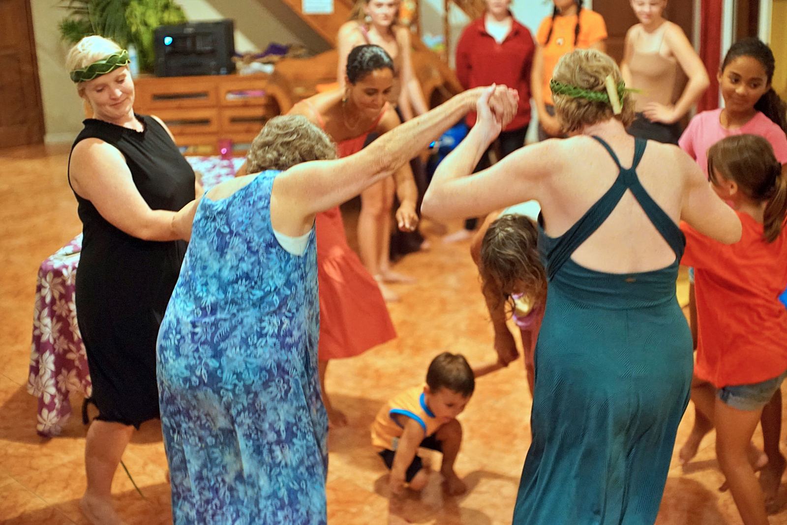 Guests and children dancing together in the evening