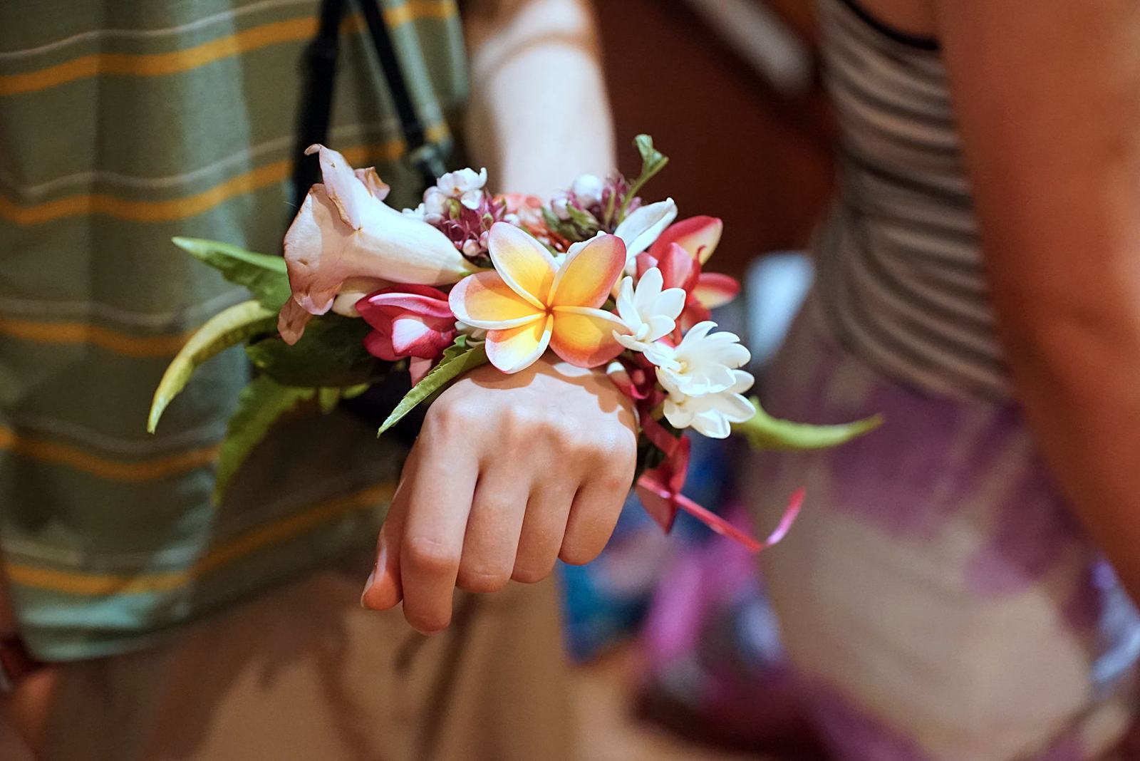 A wrist corsage of tropical flowers