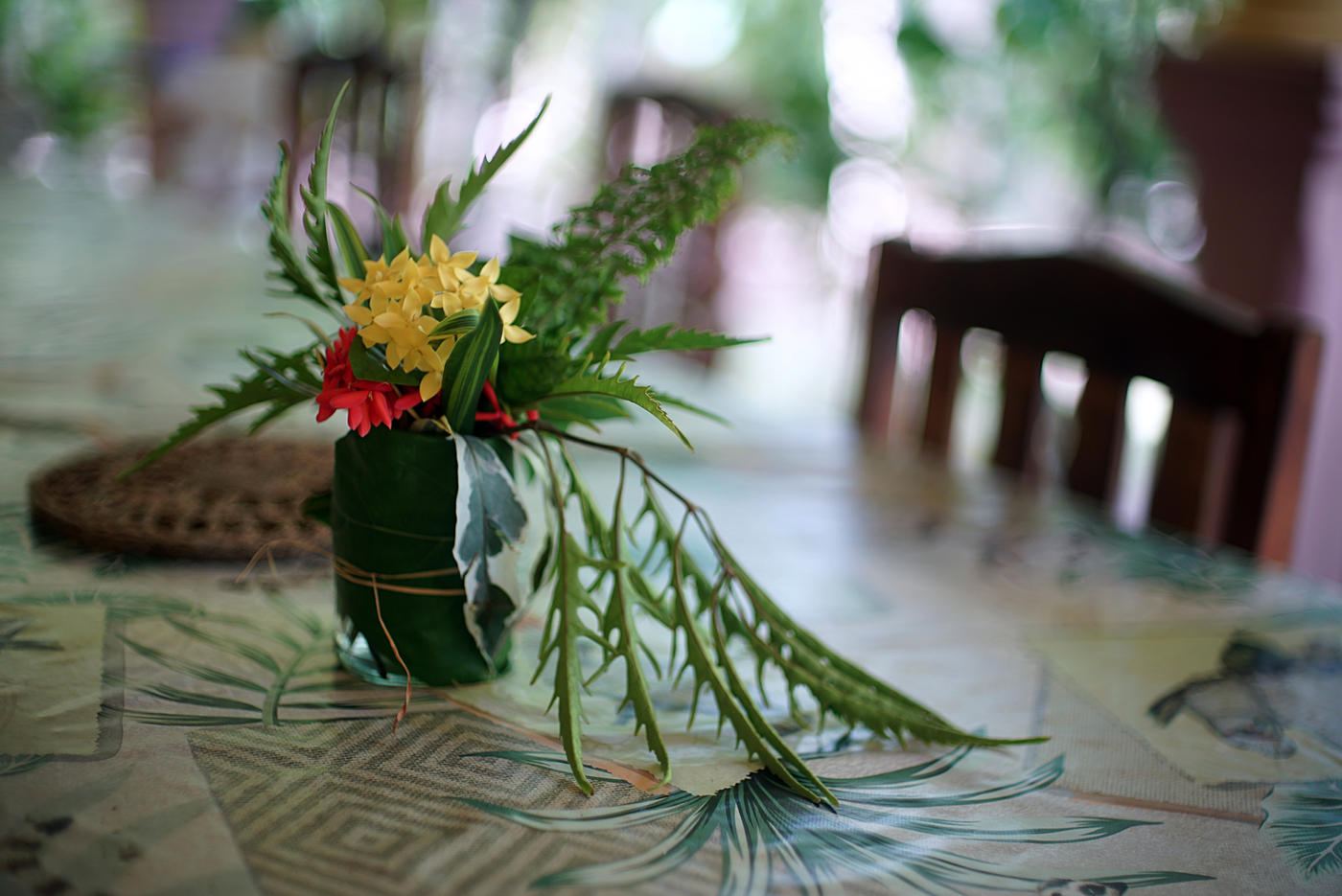 A table laid with a tropical flower arrangement